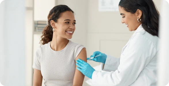 Person applying allergy test patches with white dots to another person's back