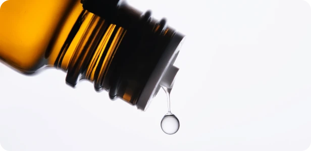 Amber glass bottle dispensing liquid medicine droplet