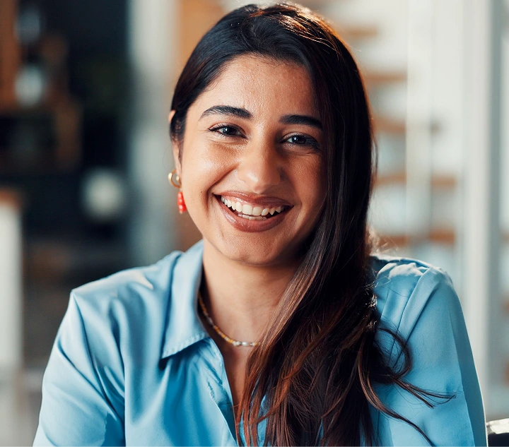 Woman smiling at camera in bright clinical setting