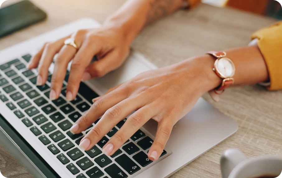 Person typing on a laptop during a virtual care session