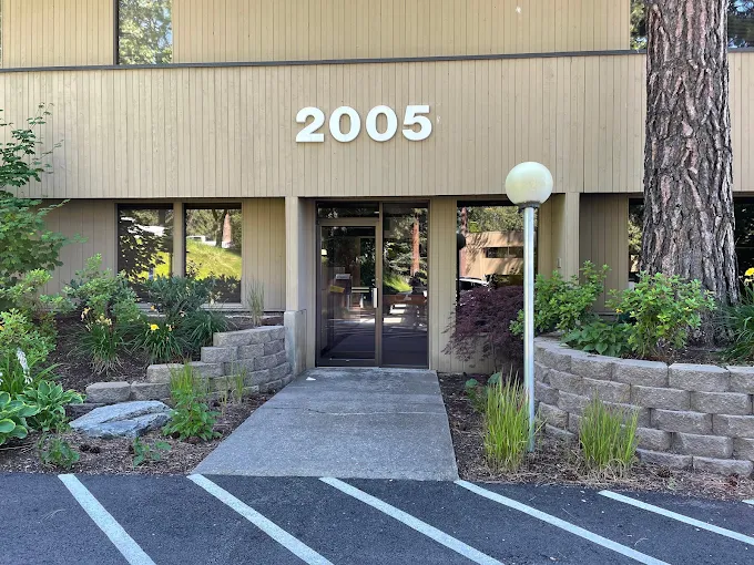 Building entrance at 2005 Ironwood Parkway with landscaping and lower parking area