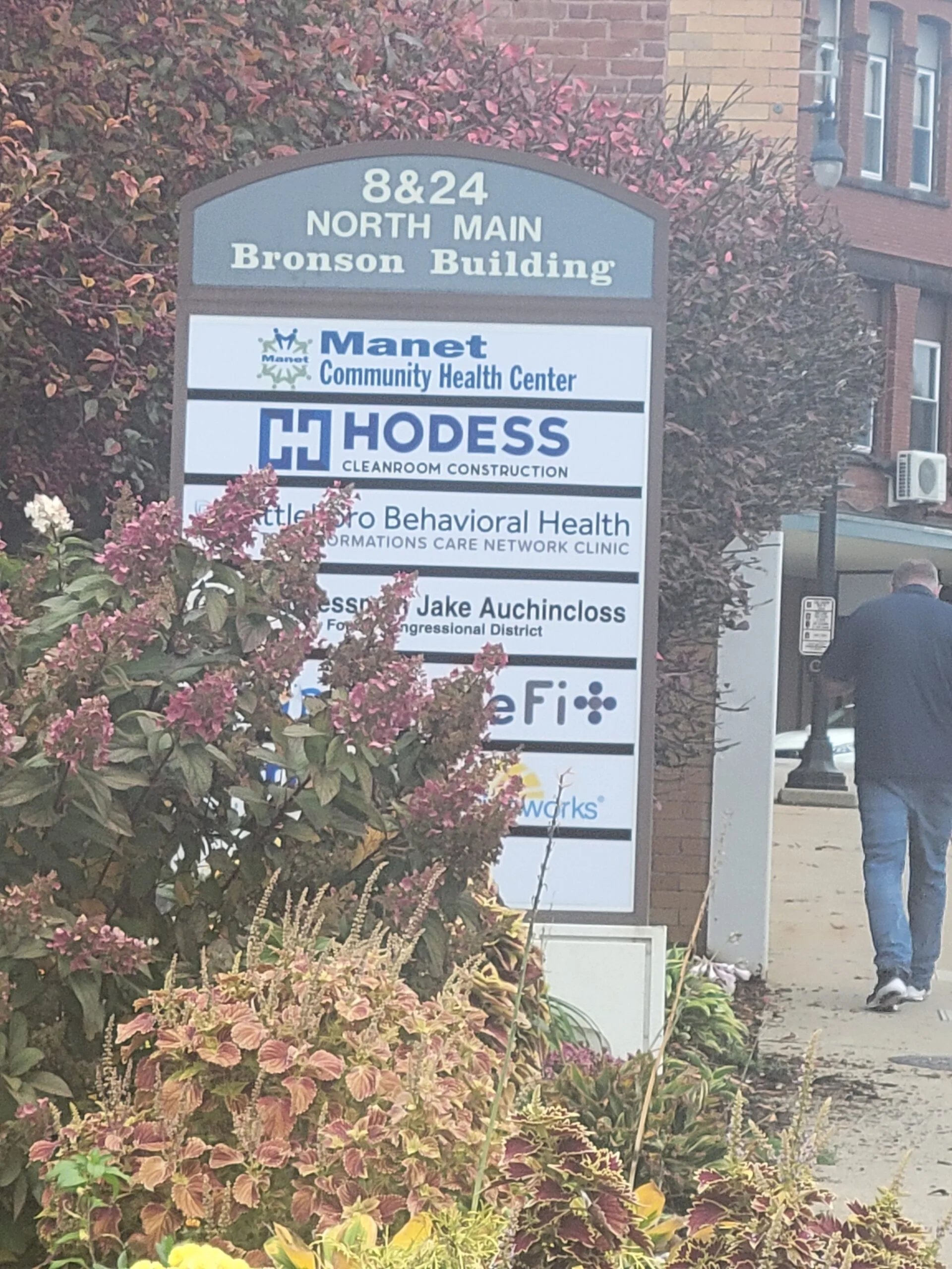 Building directory sign at 8&24 North Main listing Manet Community Health Center and other tenants