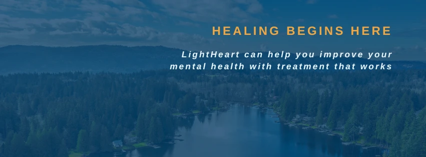 Text overlay reading 'HEALING BEGINS HERE' and 'LightHeart can help you improve your mental health with treatment that works' on a forest and water landscape background