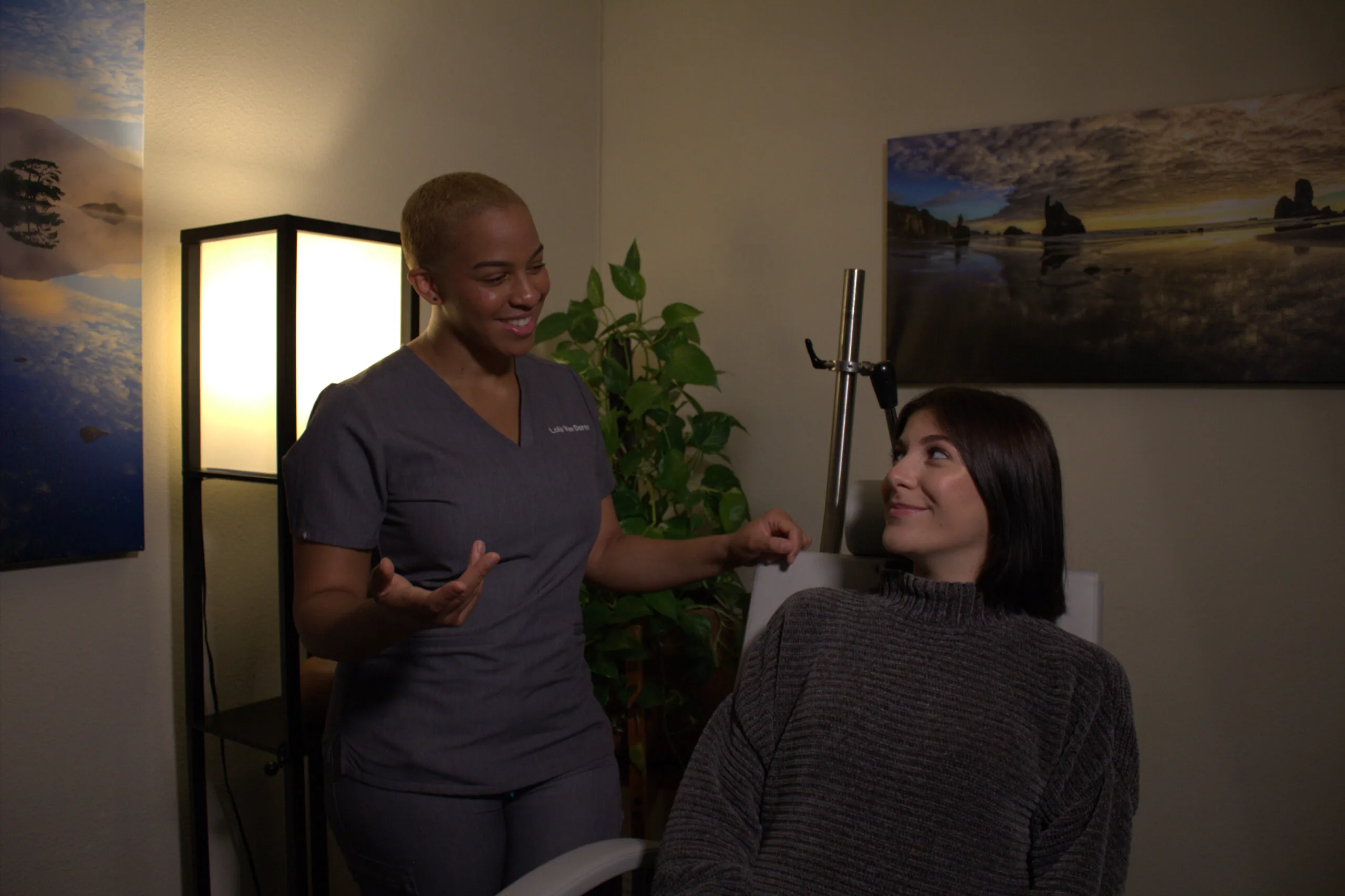 TMS therapy clinician consulting with patient in modern office with warm lighting and plants