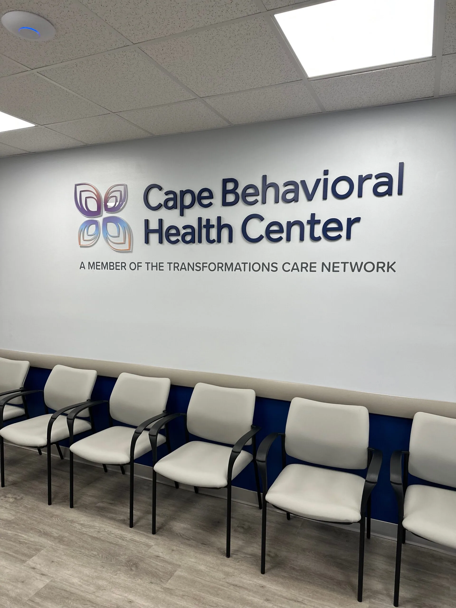 Cape Behavioral Health Center waiting room with wall signage and cushioned seating chairs