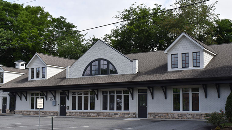 Marietta TMS therapy clinic exterior: white brick building with stone base and arched window detail
