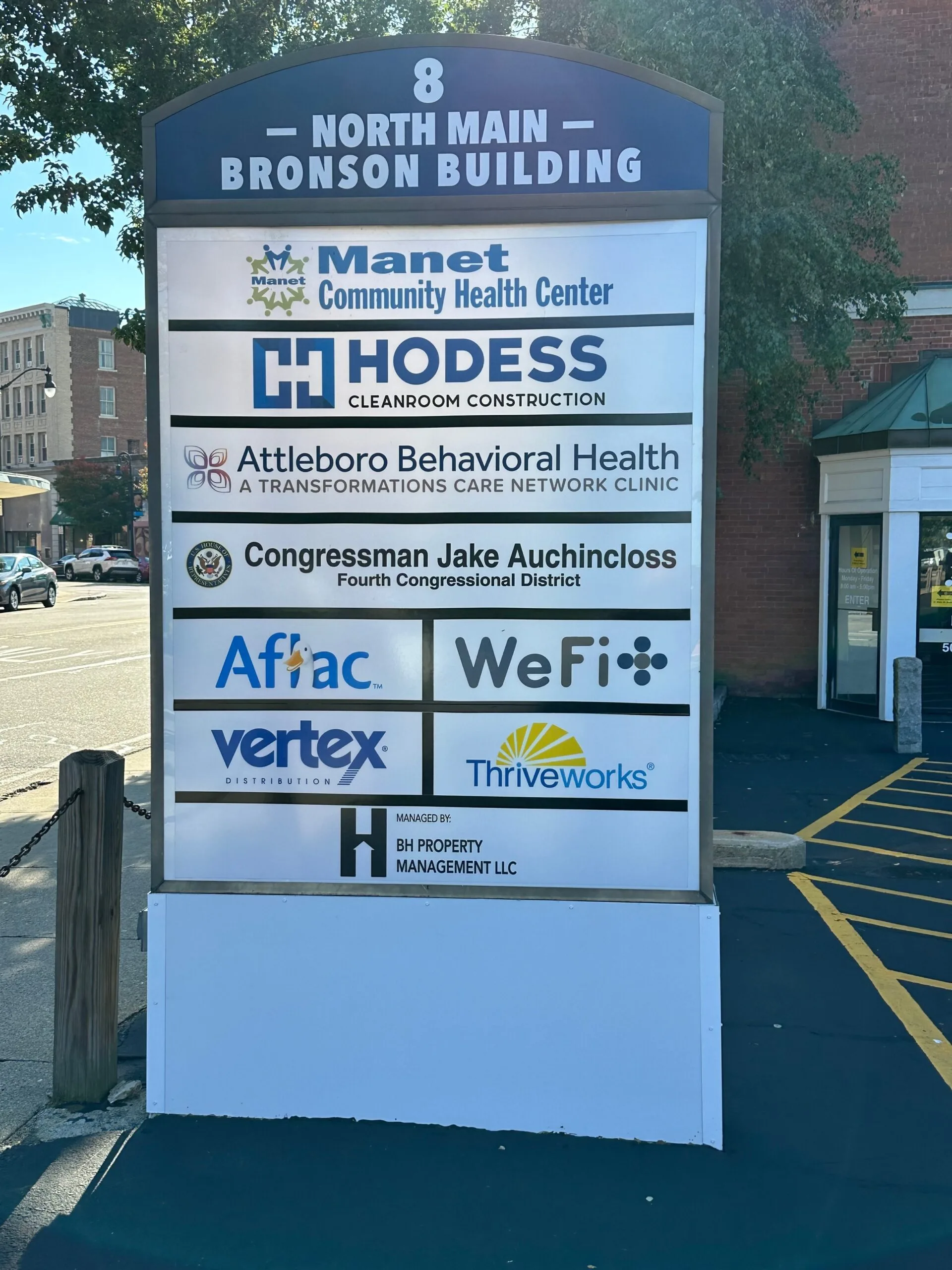 Outdoor directory sign for 8 North Main Bronson Building listing tenants including Attleboro Behavioral Health Center