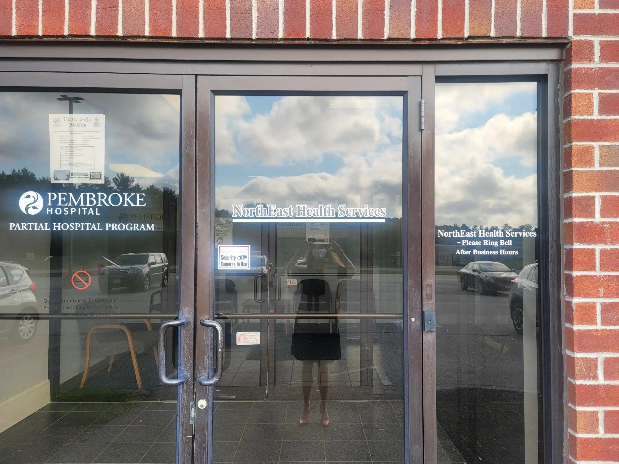 Glass entry doors displaying North East Health Services and Pembroke Hospital Partial Hospital Program signage