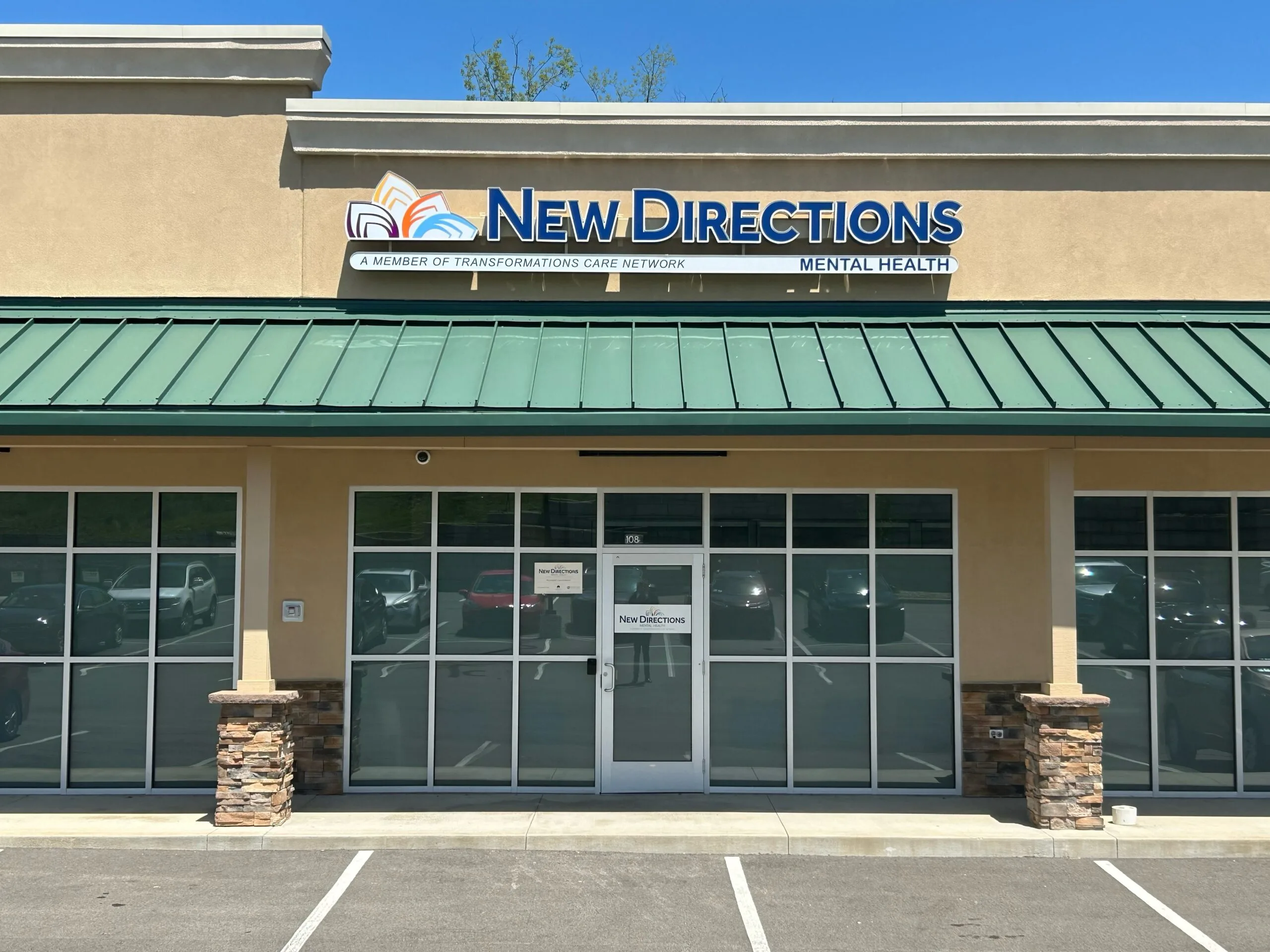 New Directions Mental Health storefront exterior with green roof and glass entrance doors