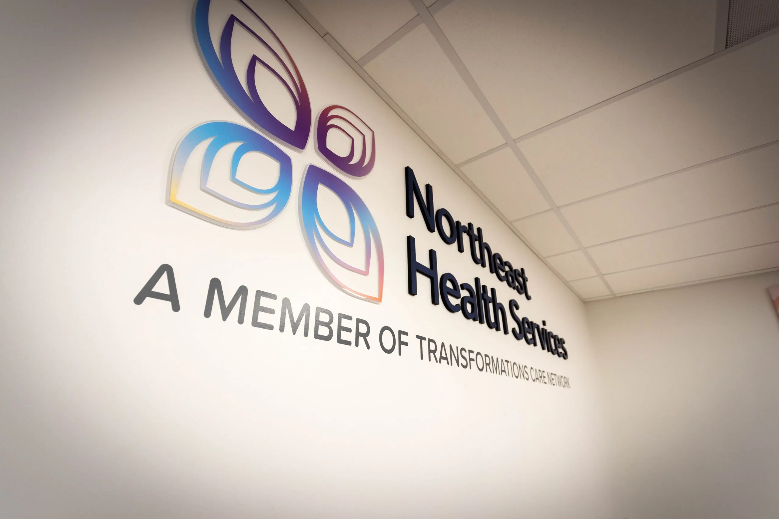 Northeast Health Services, A Member of Transformations Healthcare wall logo