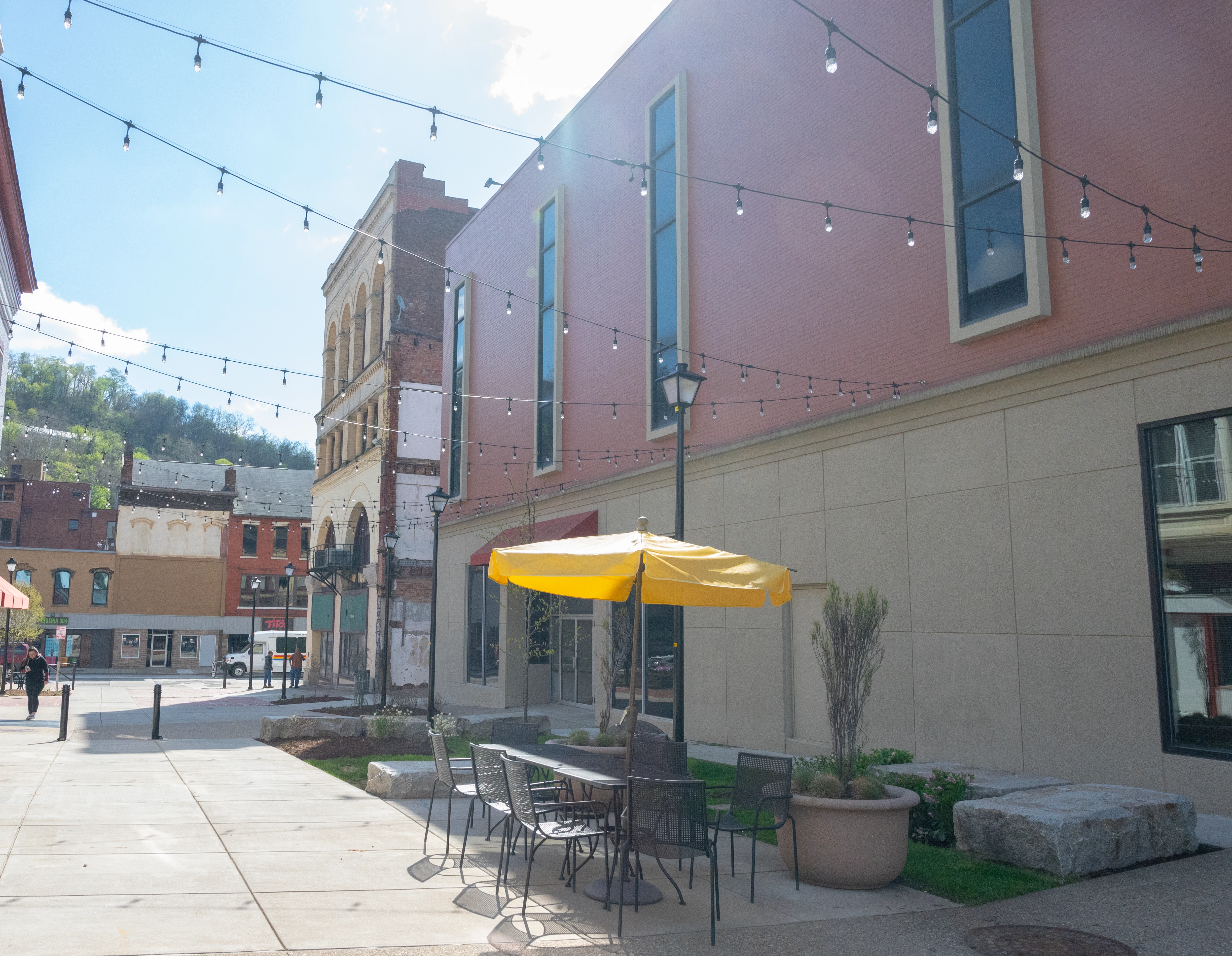 Wheeling clinic exterior with yellow umbrella over seating area and string lights