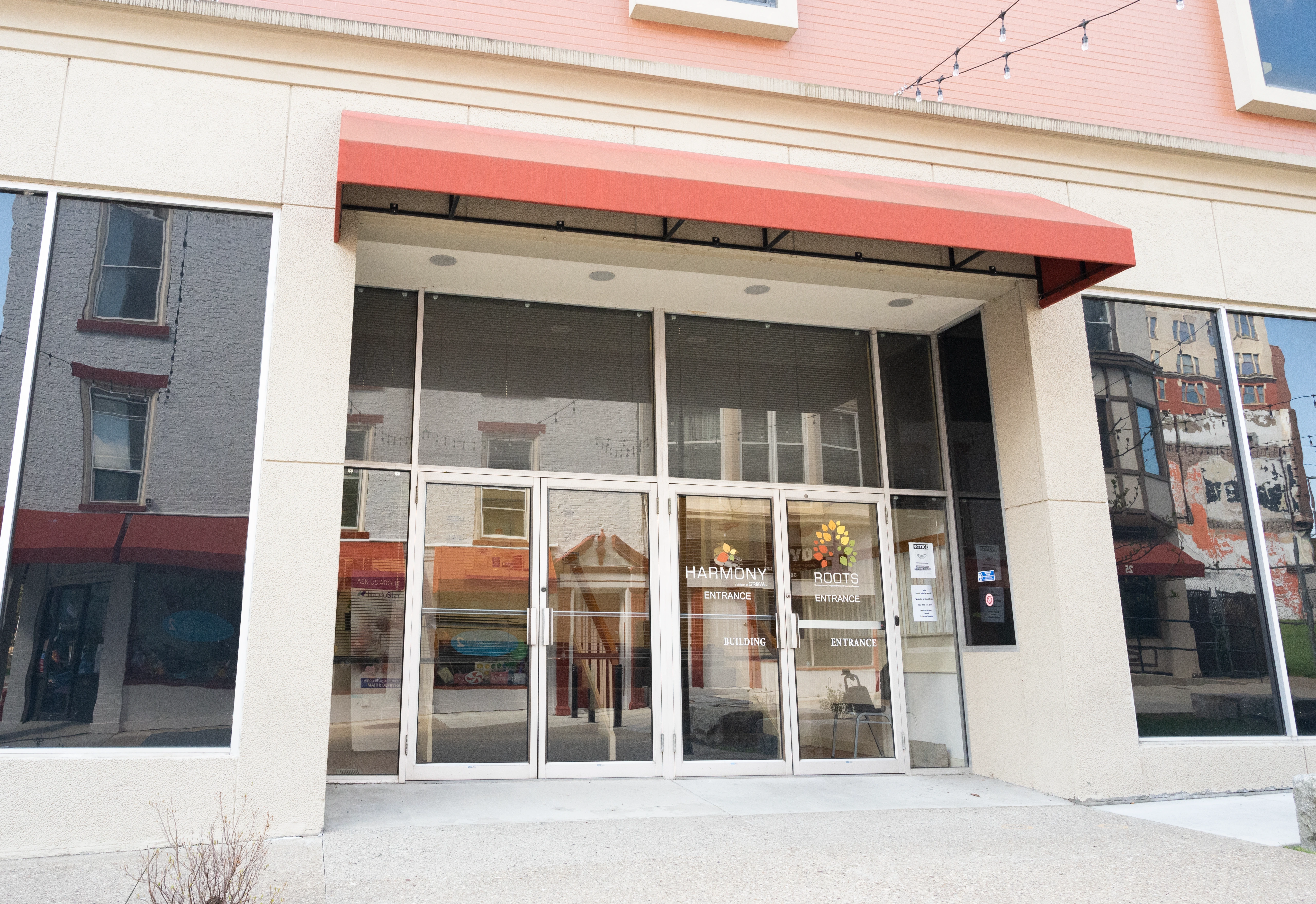 Wheeling clinic storefront with red awning, glass doors, and white facade