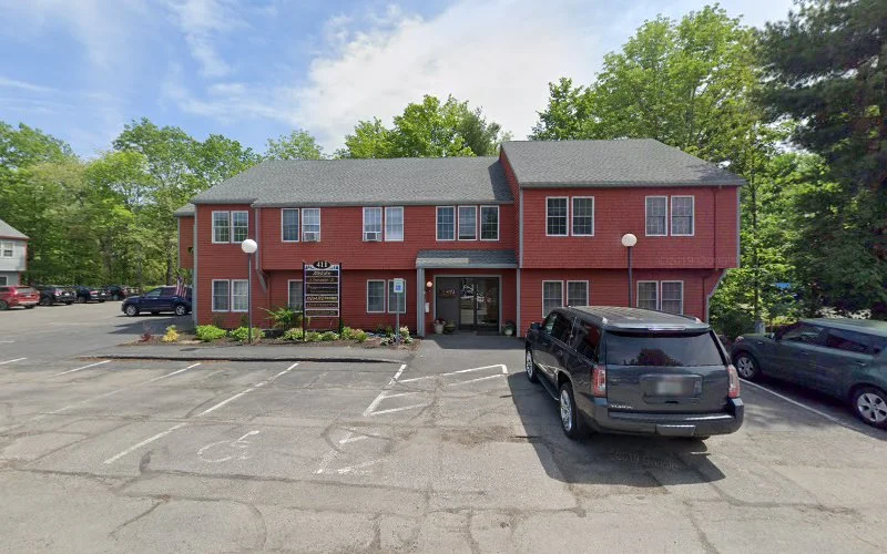 Alternative Wellness Services red brick building with parked vehicles in front