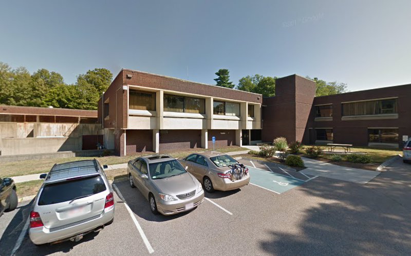 Brick medical building exterior with parking lot and accessible parking space