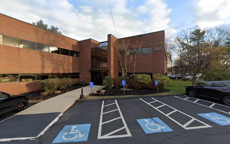 Charismatic Counseling Services brick building with accessible parking spaces marked with blue wheelchair symbols