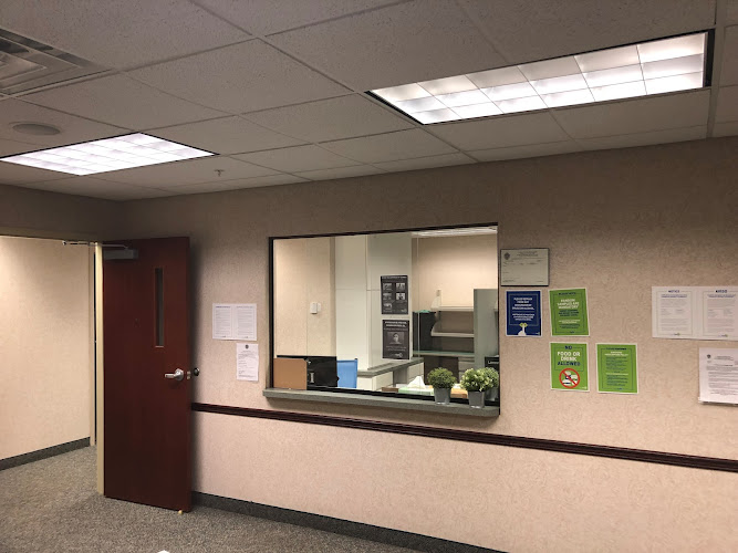 Clean Slate reception desk and waiting area with front window, informational posters, and plant