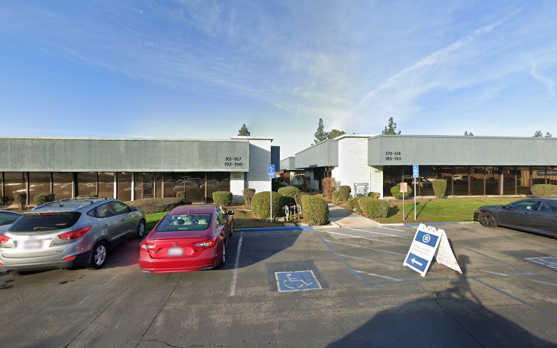Clinical TMS Society facility exterior with parking lot and landscaping