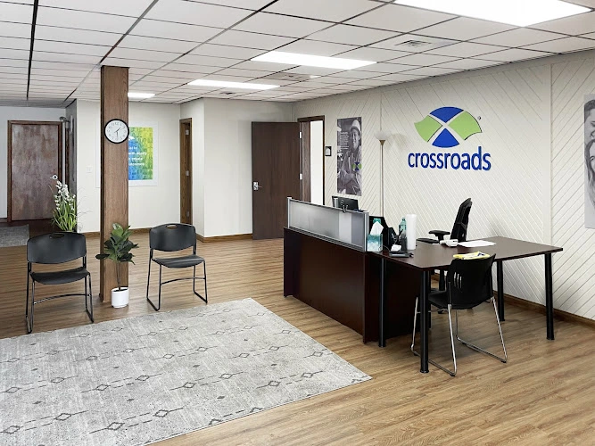 Crossroads treatment center reception area with front desk, waiting chairs, and branded wall signage