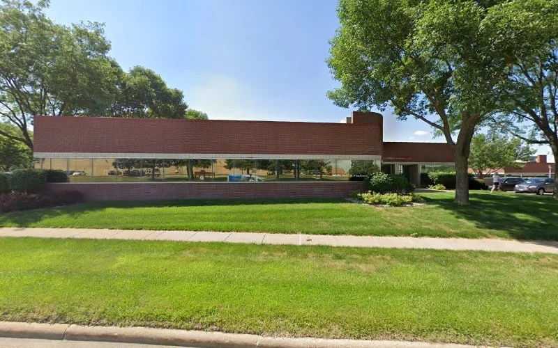Dean Rodney J MD clinic, single-story brick building with large windows and landscaped lawn