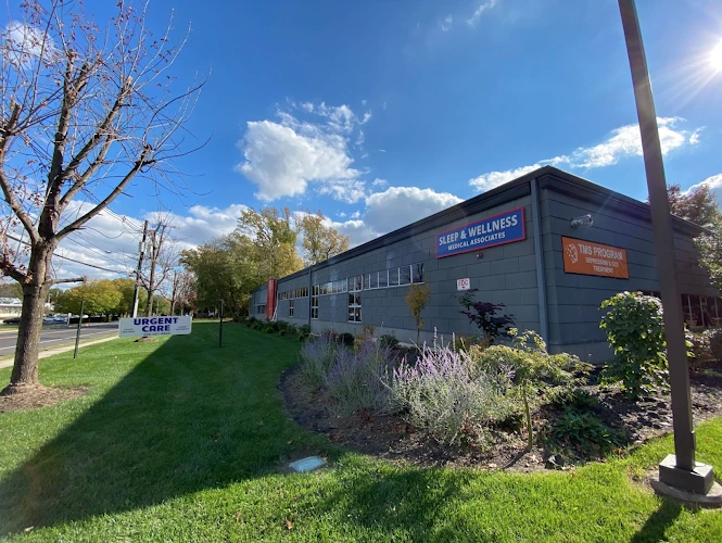 Sleep & Wellness medical clinic building exterior with landscaping and signage