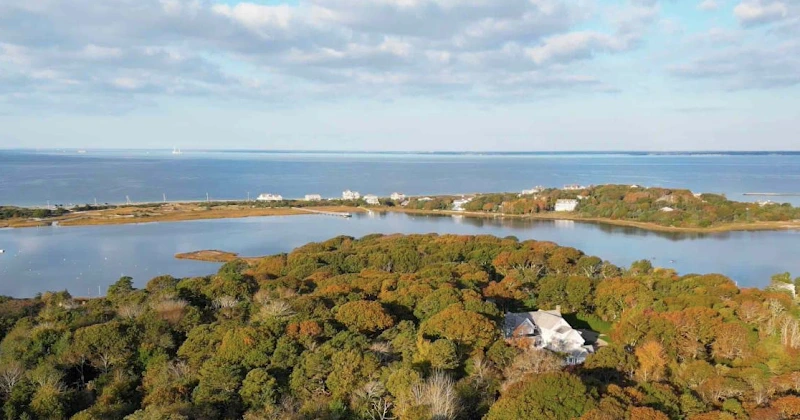 Aerial view of Gosnold Behavioral Health facility on wooded peninsula surrounded by water