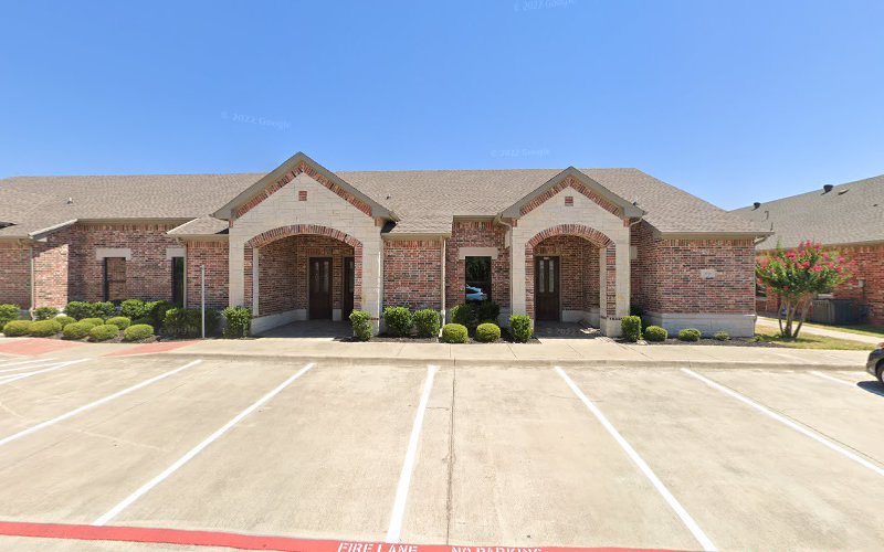 Brick medical office building exterior with arched entrances and parking lot