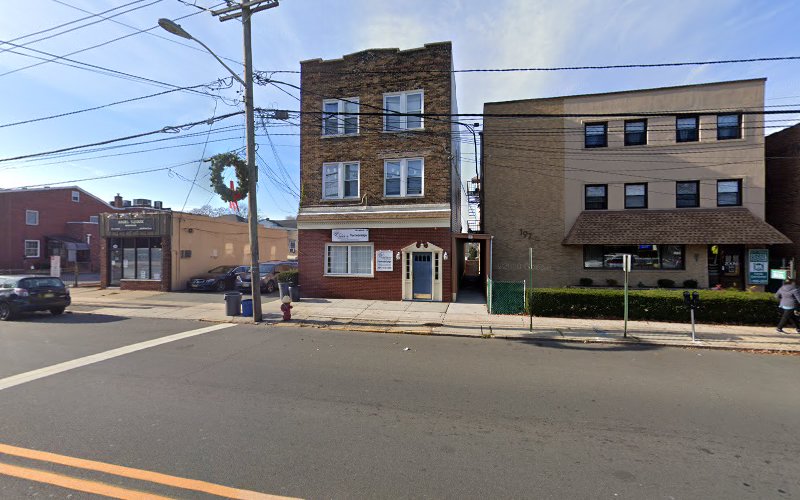 Multi-story brick and tan building housing Into the Light Wellness & Recovery Center on residential street