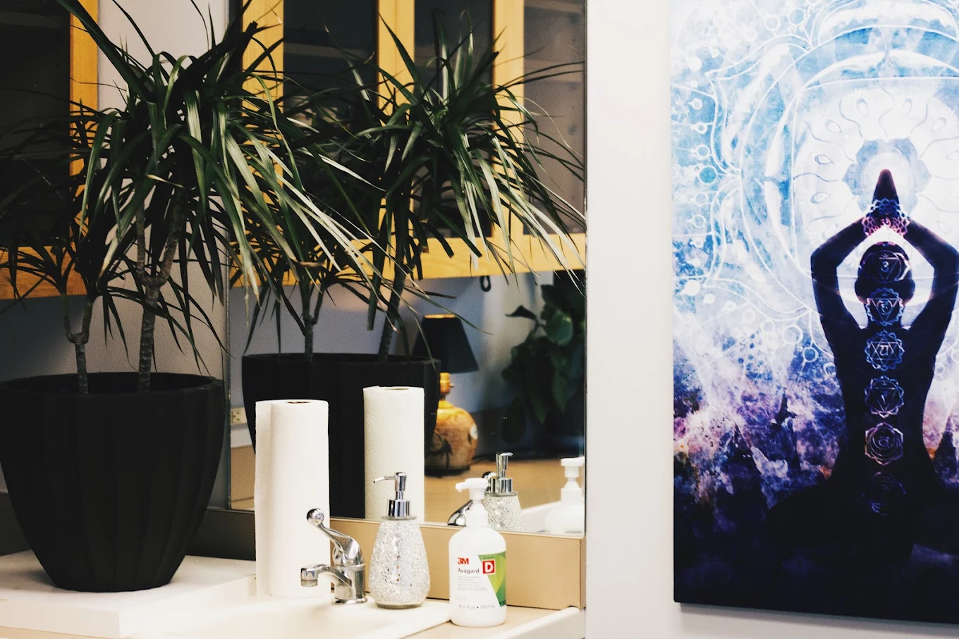 Ketamine infusion room with IV drip setup, plants, skincare products, and wellness artwork