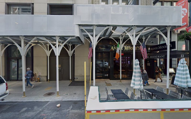 Street-level storefront with white architectural awning and shop windows