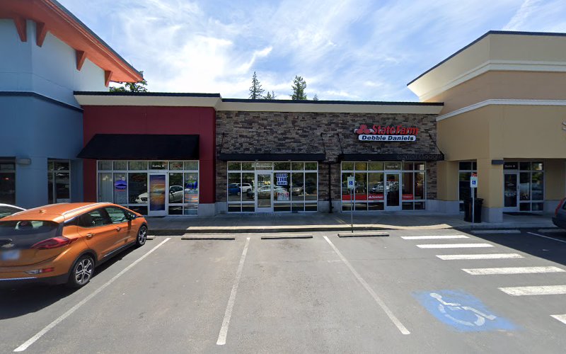 Medical plaza exterior with multi-colored storefronts and parking lot