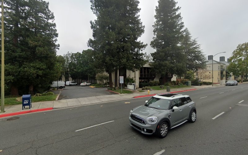 Medical building exterior in Los Gatos with trees and parked vehicles