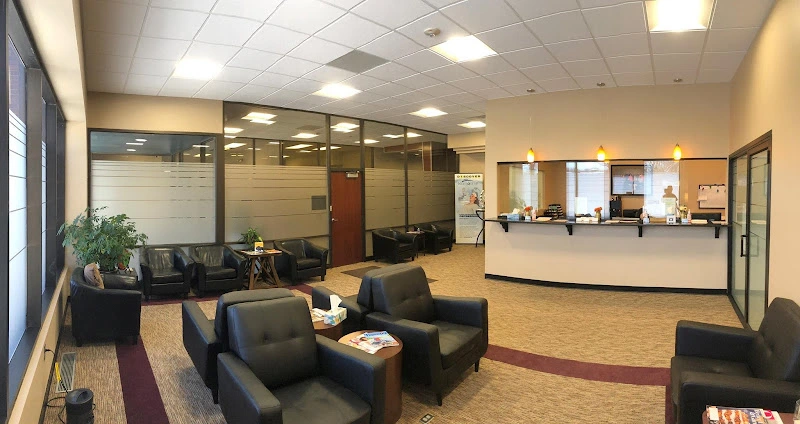 Meridian Mental Health reception area with black seating, front desk, and glass-walled offices