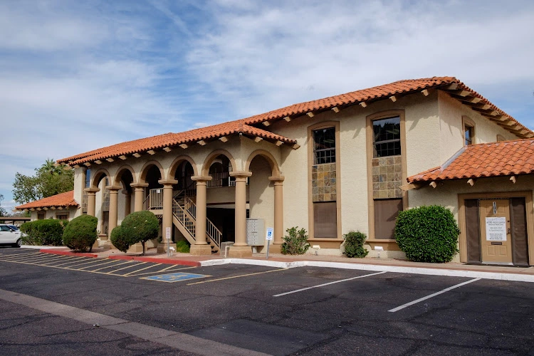 NeuroFocus Center, LLC Spanish-style stucco building with arched entrance and tile roof