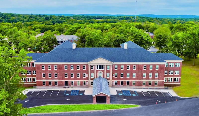 Northern Medical Center brick building with blue roof surrounded by trees and landscaping
