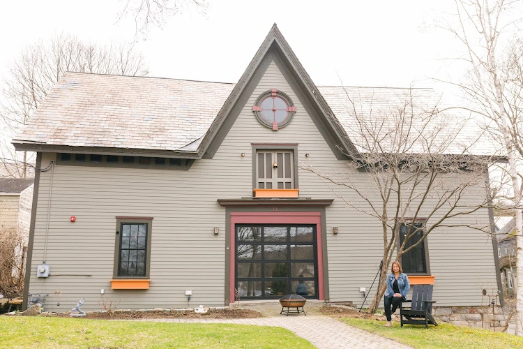 Optimal Healing LLC residential-style building with woman sitting on front steps