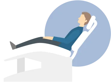 Patient reclined in treatment chair during TMS therapy preparation