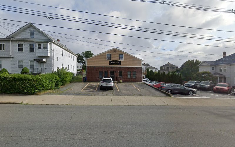 Brown brick psychiatric office building with parking lot and residential neighborhood