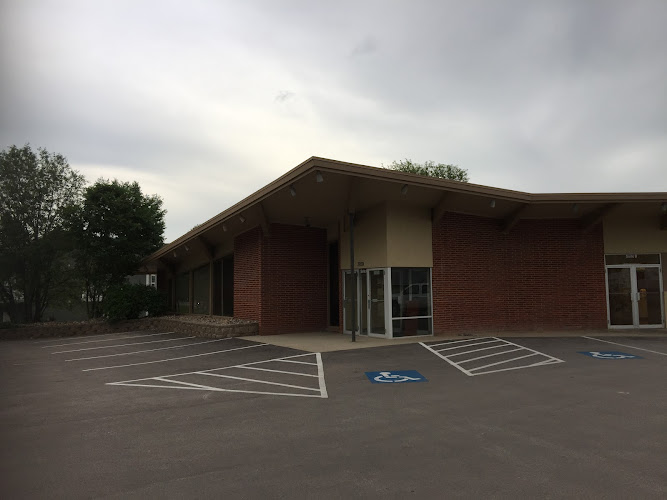 Brick medical building exterior with parking lot and accessible parking spaces