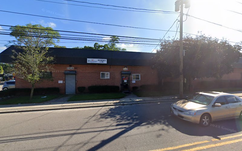 Risewell Community Services brick building exterior with parking lot and parked vehicle