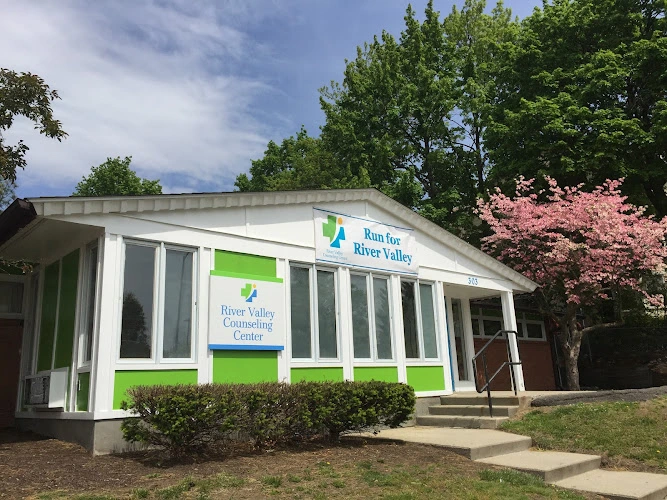 River Valley Counseling Center single-story white building with green and blue signage and entry walkway