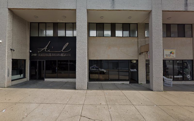 Multi-tenant storefront building with dark glass entrance doors and ground-level retail spaces