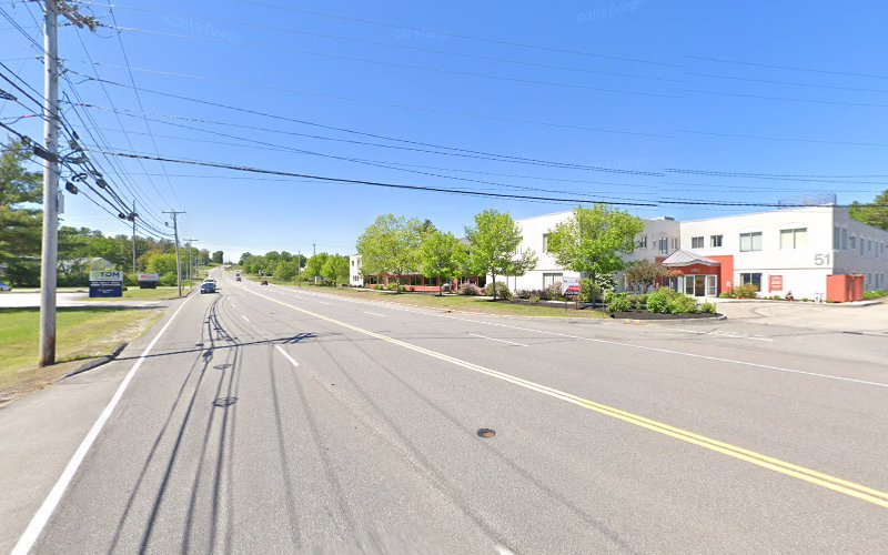 Street view of Southern Maine TMS clinic building with red entrance and surrounding trees