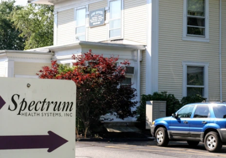 Spectrum Health Systems, Inc. building exterior with blue vehicle parked in front