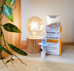 Spravato (esketamine) nasal spray 56 mg dose kit with two 28 mg devices displayed next to a wooden lamp