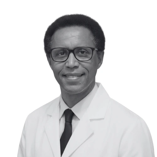 Talargie Tafesse, male healthcare provider wearing glasses and white coat with black tie