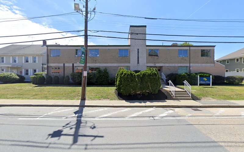 The Counseling Center at Millbury brick building with blue signage and entrance ramp on a residential street