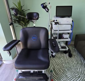 Magstim TMS coil positioned above patient treatment chair with control console