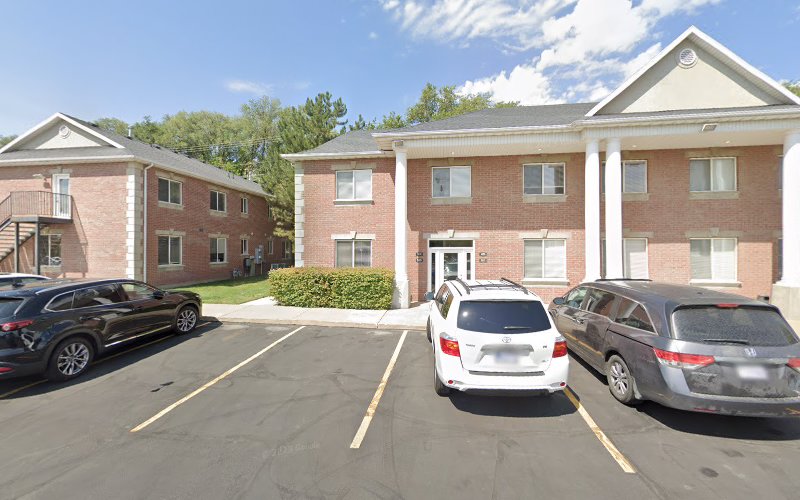 TMS Solutions Ogden brick building exterior with parking lot and vehicles
