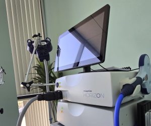 Magstim Horizon TMS device with monitor and treatment coil on adjustable stand