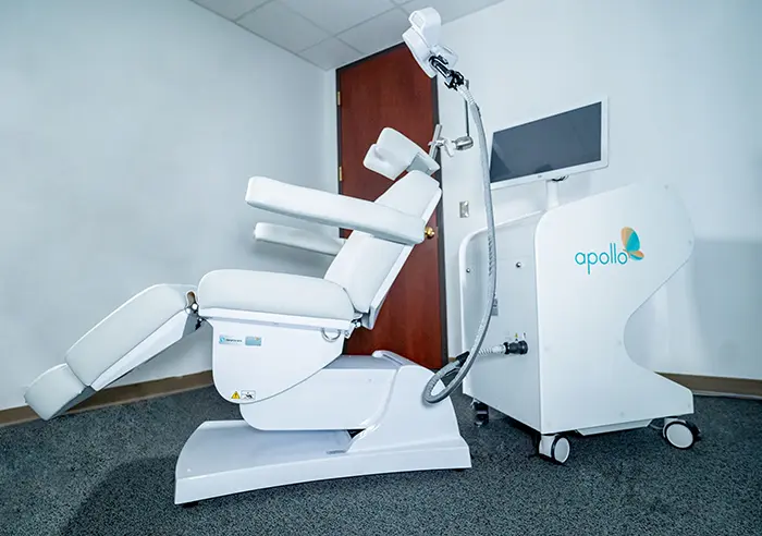 Apollo TMS device - white and blue transcranial magnetic stimulation machine in clinical treatment room